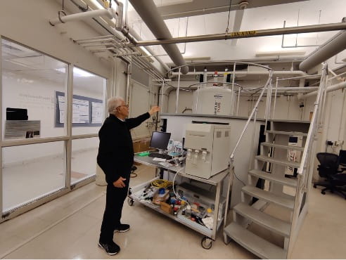 man in front of high-tech laboratory machinery